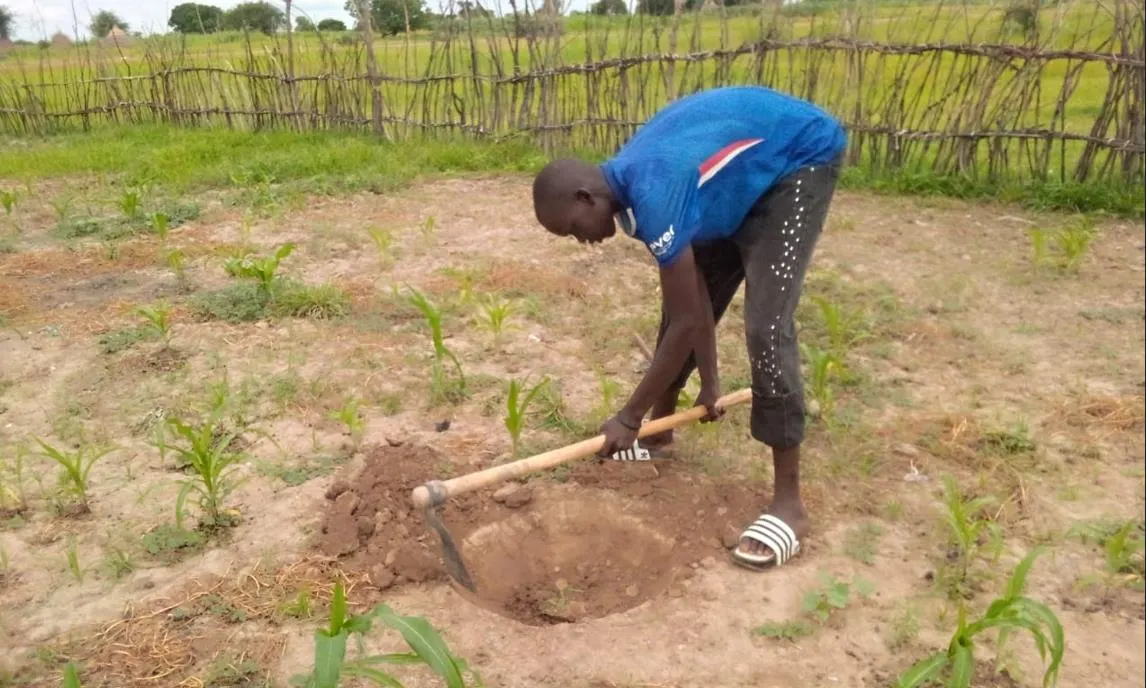 Community volunteers excavating planting holes.