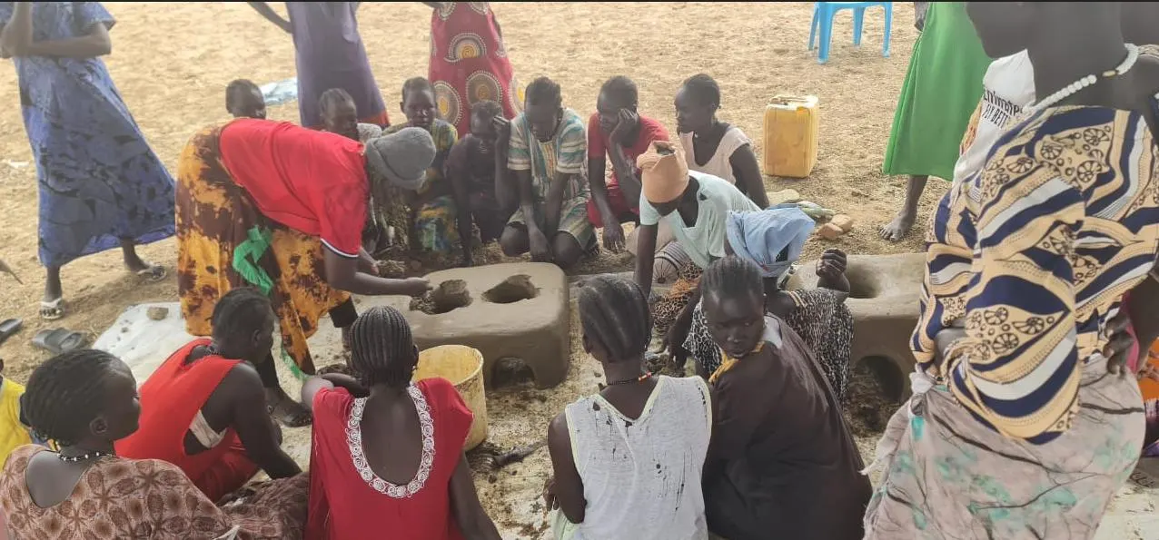 Women participating in practical stove moulding exercises.