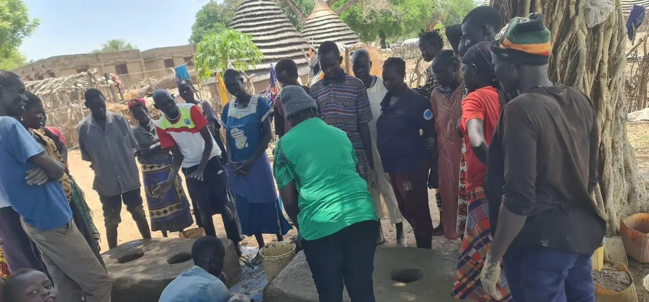 Production groups and trainers reviewing stove quality standards.